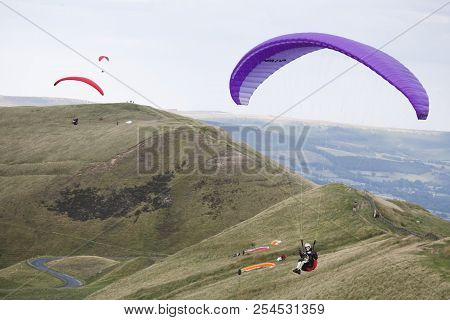 Peak District, Uk - August 08, 2007. A Group Of Paragliders Fly From Rushup Edge In The Peak Distric