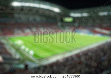 Blurred Field With Lights And Full Of Spectators At The Stadium One Step At A Sporting Event
