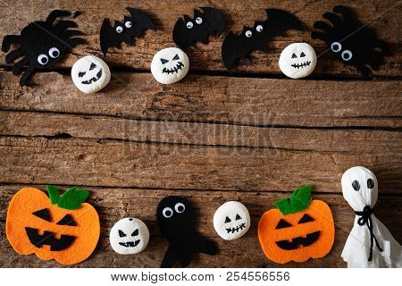Top View Of Halloween Crafts, Orange Pumpkin, Ghost And Spide On Wooden Background With Copy Space F