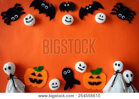 Top View Of Halloween Crafts, Orange Pumpkin, Ghost And Spide On Orange Background With Copy Space F