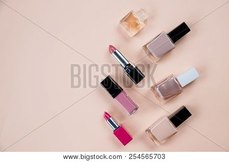 Cosmetics Top View On Beige Table. Workplace, Cosmetics, Lipstick, Nail Polish, Make Up Pettern.set 
