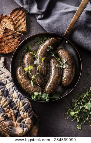 Roasted Sausages In Pan With Bread And Herbs.