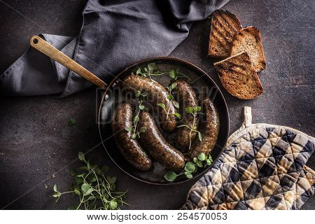 Roasted Sausages In Pan With Bread And Herbs.