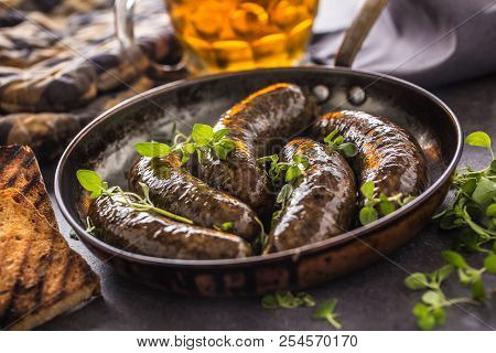 Roasted Sausages In Pan With Bread Herbs And Draft Beer.