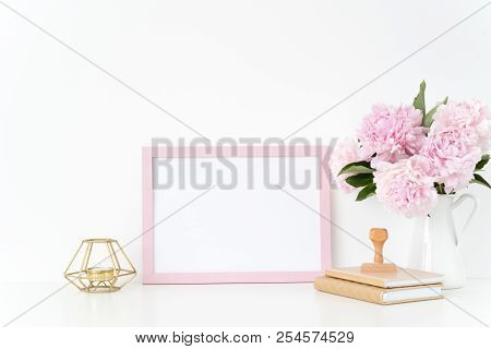 Pink Landscape Frame Mock Up With A Pink Peonies, Candle And Stamp Beside The Frame, Overlay Your Qu