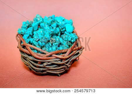 Pile Stones Of Raw Turquoise In Small Wooden Nest On A Brown Background. Blue And Green Color Stones