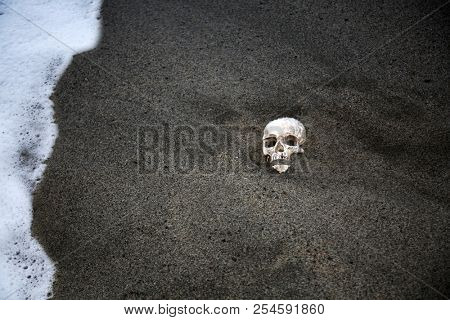 Voodoo Skull. Scary Halloween Skull on a beach with waves. Voodoo Sacrifice at the beach at Sunset.  
