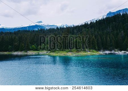 Caumasee Lake With A Small Island Located In The Middle Of The Crystal Clean Lake, Near Flims, Switz