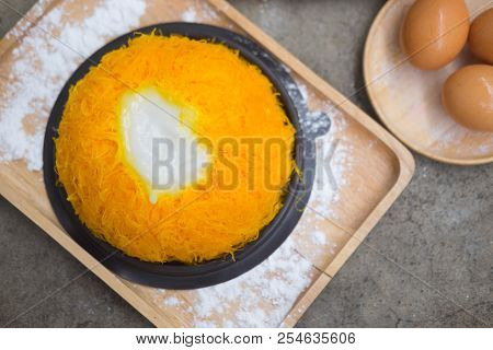 Foi Thong Lava Cake With Coconut Sauce Served On Wooden Tray