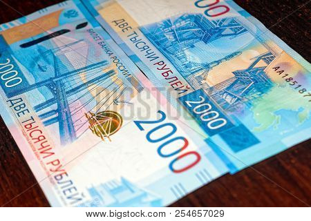 Russian Two Thousandth Notes Close-up Against The Background Of A Dark Wooden Table