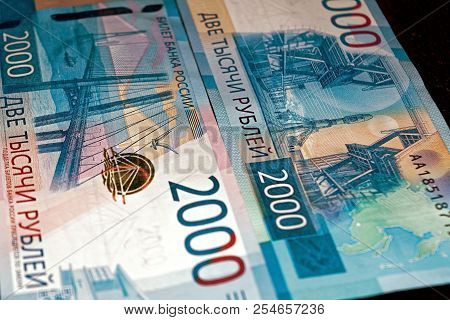 Russian Two Thousandth Notes Close-up Against The Background Of A Dark Wooden Table