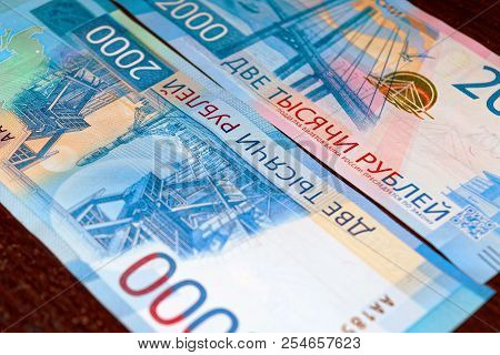 Russian Two Thousandth Notes Close-up Against The Background Of A Dark Wooden Table