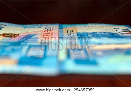 Russian Two Thousandth Notes Close-up Against The Background Of A Dark Wooden Table