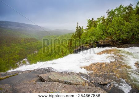 View Of Green Mountain From Valnesforsen Waterfall In Norway