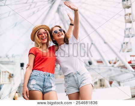 Happy Brightful Positive Moments Of Two Stylish Girls Hugging On Street In City. Closeup Portrait Fu