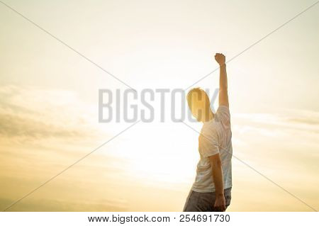Jumping Man. Young Crazy Man Is Jumping On Rocky Summit Above Landscape. Silhouette Of Jumping Man A