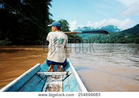 Nong Khiaw / Laos - Jul 06 2011: Lao Fisherman Istalom At Work At One Of The Small River Stream Lead