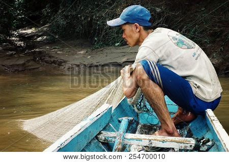 Nong Khiaw / Laos - Jul 06 2011: Lao Fisherman Istalom At Work At One Of The Small River Stream Lead
