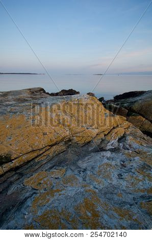 Yellow Ochre Of Rocks On Cattle Point At Sunset With Juan De Fuca Strait In The Distance. Wide Angle
