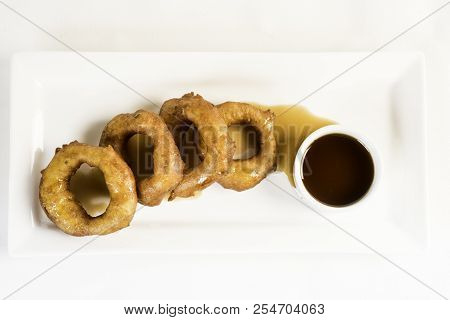 Picarones: These Are Ring-shaped Dessert Made With Wheat Flour Dough Mixed With Pumpkin And Sweet Po