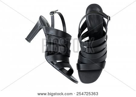Black slingback high heel sandals with multi strap details. Fastens with a silver metal buckle closure. New beautiful shoes for lady isolated on white background, top view. 