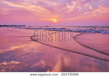 Romantic Sunset On The Beach Of Chaung Tha, The Colorful Cloudy Sky Is Reflected In Swash Waves Of B