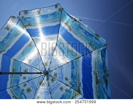 Sun Beach Umbrella Parasol On Sunny Day On Background Of A Blue Sky Giving Shade And Protection