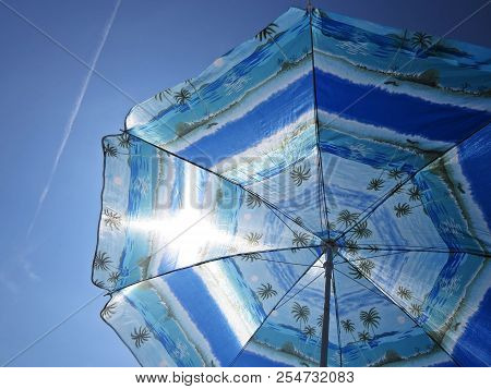 Sun Beach Umbrella Parasol On Sunny Day On Background Of A Blue Sky Giving Shade And Protection