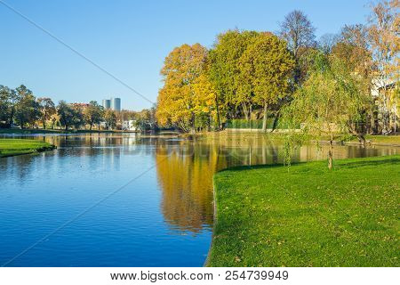 Pond In Riga, District Agenskalsns. Autumn, Yellow Tree Leaves, Lake And Reflection. 2017