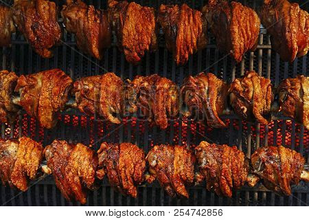 Several Traditional Bavarian German Roasted Pork Knuckles Slowly Cooked At Rotating Broiling Rack Gr