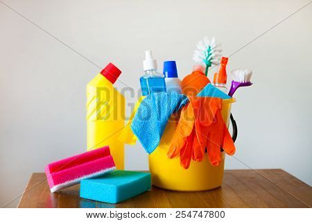 Basket With Cleaning Items On Blurry Background White Citchen. Cleaning Concept.