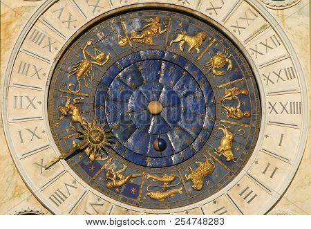 Ancient time, astrology and horoscope. Detail of Saint Mark Square old Clocktower with zodiac signs, planets and stars (15th century)