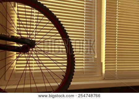 Bicycle Wheel On The Background Of Blinds