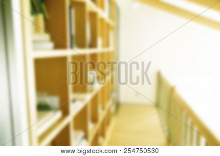 Abstract Blurred Modern White Bookshelves With Books. Blur Manuals And Textbooks On Bookshelves In L