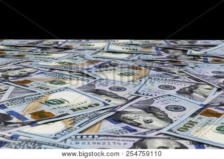 Stack Of One Hundred Dollar Bills Isolated On Black Background. Stack Of Cash Money In Hundred Dolla