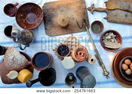 Still Life With Rural Repast Of Antique French Wooden And Metal Utensils, Vintage Scales And Simple 