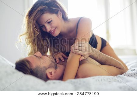 Attractive Sexy Woman With Her Partner In Bedroom
