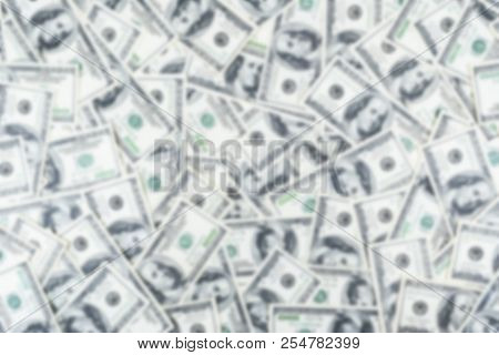 Blurred Background With Stack Of One Hundred Dollar Bills. Blur Stack Of Cash Money In Hundred Dolla