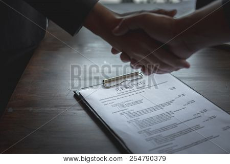 Handshake Success Job Interviewing. Job Applicant Having Interview. Shaking Hand With Resume On Desk