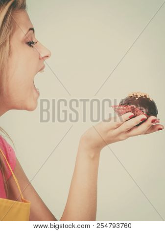 Diet, Sweets, Food Concept. Woman Holding Delicious Chocolate Cupcake With Peanut Frosting About To 