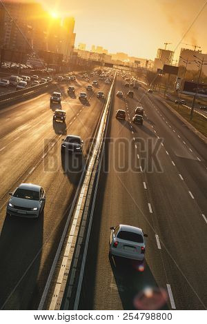 Cars On Highway. Sunset Cityscape. Contrejour Wallpaper