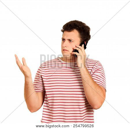 Nervous Angry Guy With Serious Expression, Having Phone Conversation. Negative Reaction. Emotional G