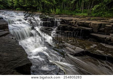 Scenic Michigan Waterfall Landscape. Beautiful Quartzite Falls Flows Through A Gorge On The Slate Ri