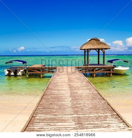 Sandy tropical Wolmar beach at sunny day. Jetty on the foreground. Beautiful landscape. Mauritius