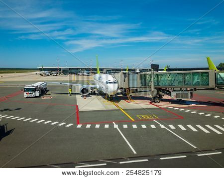Riga, Latvia - July 8, 2018: Airbaltic airlines airplane boarding at the domestic airport at day time