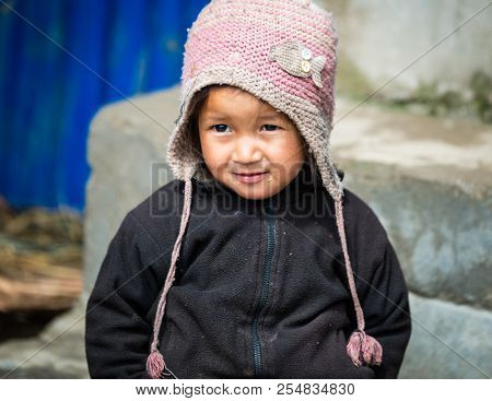 GHALEGAUN, NEPAL - CIRCA MAY 2018: Young Nepali girl wearing a pink cap.