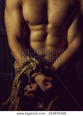 Sport. Young Man With Muscular Body Tied With Rope