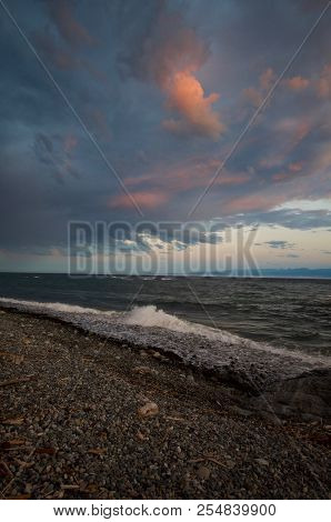 Vertical Shot Of Sunset Colored Storm Clouds Over Juan De Fuca Strait, Waves Breaking On The Beach I