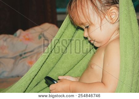 A Child With Wet Hair Wrapped In A Green Towel. Healthy Lifestyle