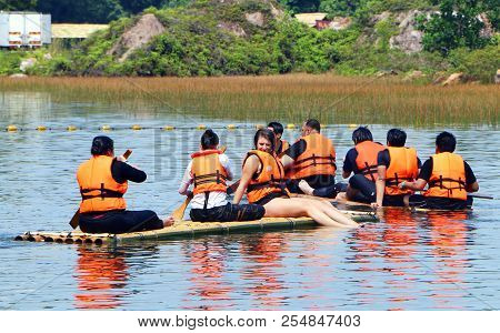 Banting, Selangor, Malaysia - July 28, 2018 : Tourist Rowing And Sitting On The Bamboo Raft Floating